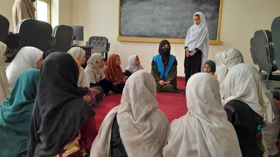 Sahar*, con un grupo de mujeres en Lower Shiekh Mesri School, en Nangarhar, Afganistán, donde da clases de manera voluntaria. © Talwasa Sakhizai/WADAN (socio de ACNUR)