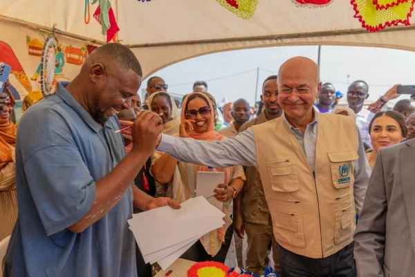 El artista refugiado sudanés Mohammed Ibrahim (izquierda) dibuja al Alto Comisionado de las Naciones Unidas para los Refugiados, Barham Salih (derecha), en el asentamiento de refugiados de Ura, en Etiopía. © ACNUR/Charity Nzomo